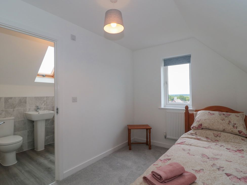 A bedroom with a bed and bathroom access at 56 Strothers Avenue Malvern