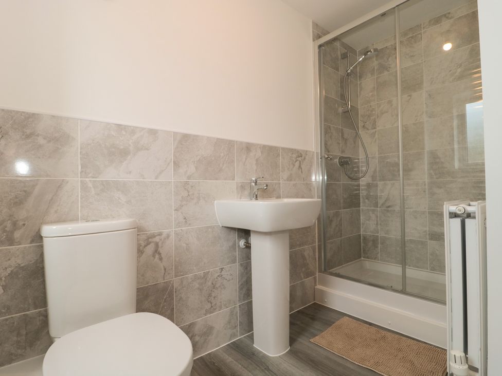 A bathroom with a shower, sink, and toilet at 56 Strothers Avenue Malvern
