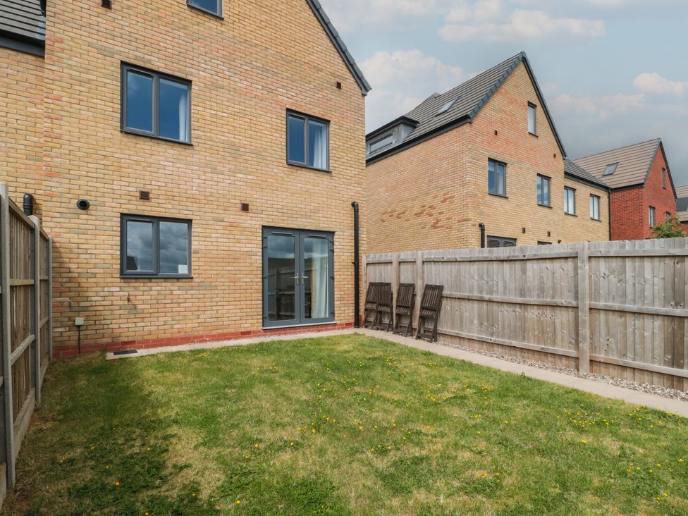 A garden area with a house and chairs at 56 Strothers Avenue Malvern