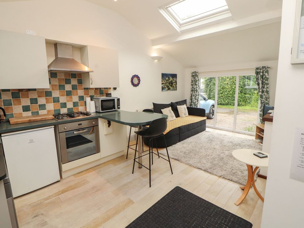 A kitchen with a gas stove and refrigerator at Juniper Hayloft in Ambleside
