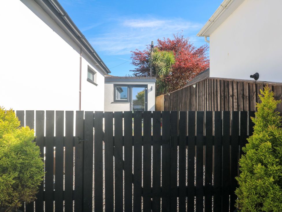 A garden with a black gate and house visible at The Annex in Penzance