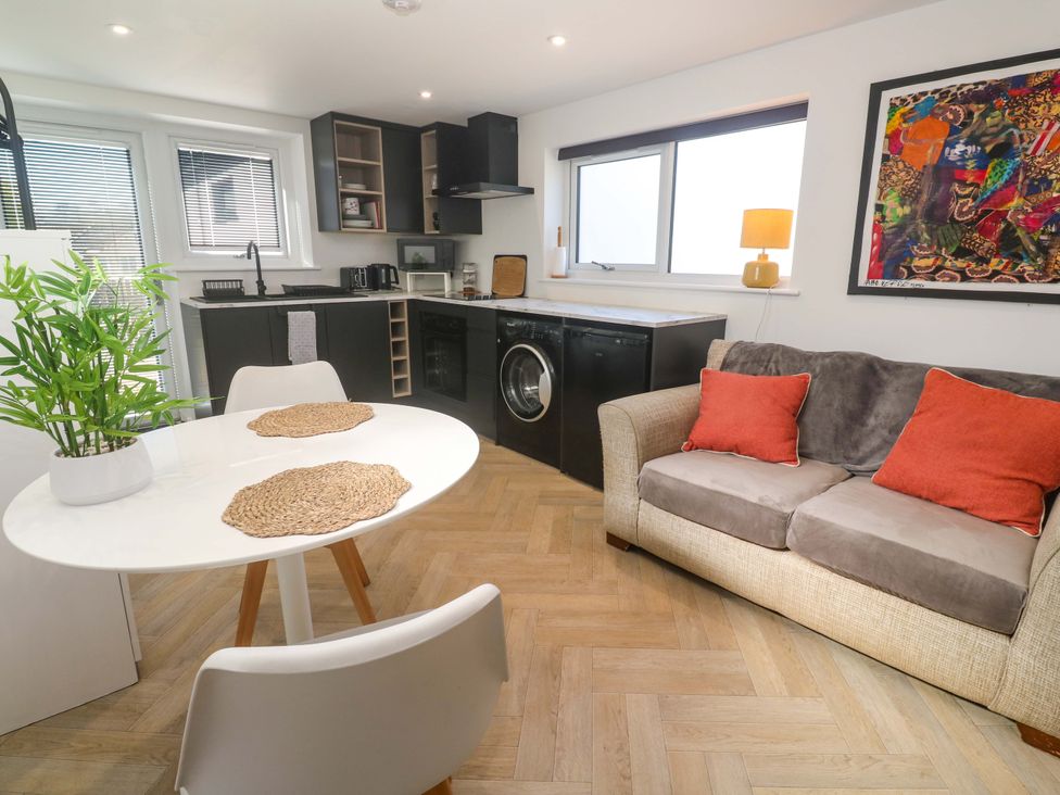 A kitchen with a dining table and sofa at The Annex in Penzance