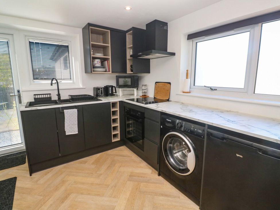 A kitchen with appliances and cabinets at The Annex in Penzance