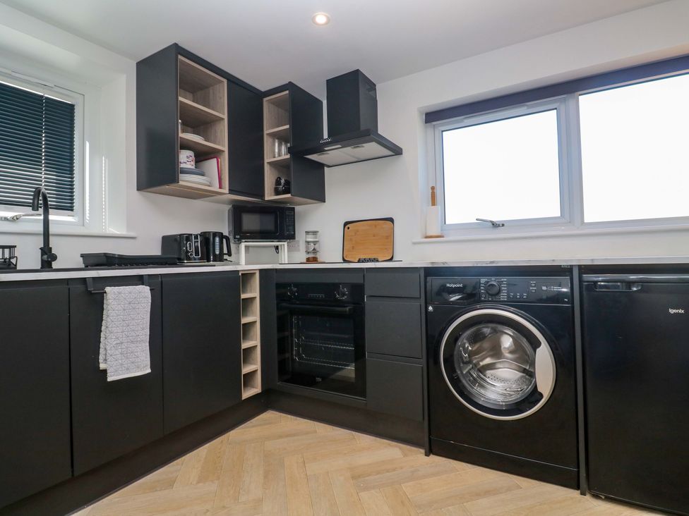 A kitchen with appliances and cabinets at The Annex in Penzance