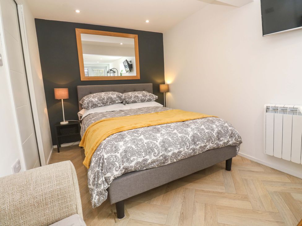 A bedroom with a bed and nightstand at The Annex in Penzance
