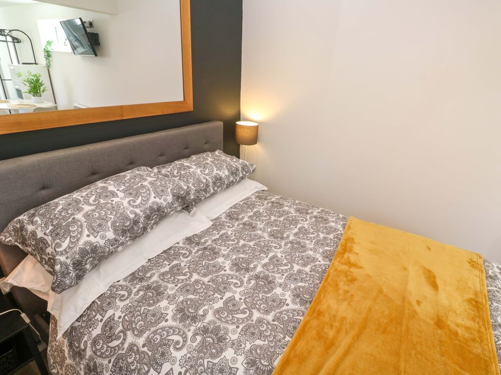 A bedroom with a bed and decorative pillows at The Annex in Penzance