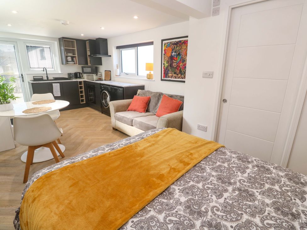 A studio with a bed and kitchen area at The Annex in Penzance