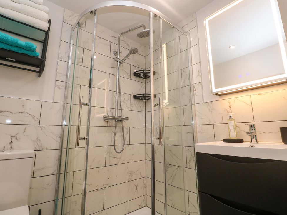 A bathroom with a shower, toilet, and sink at The Annex in Penzance