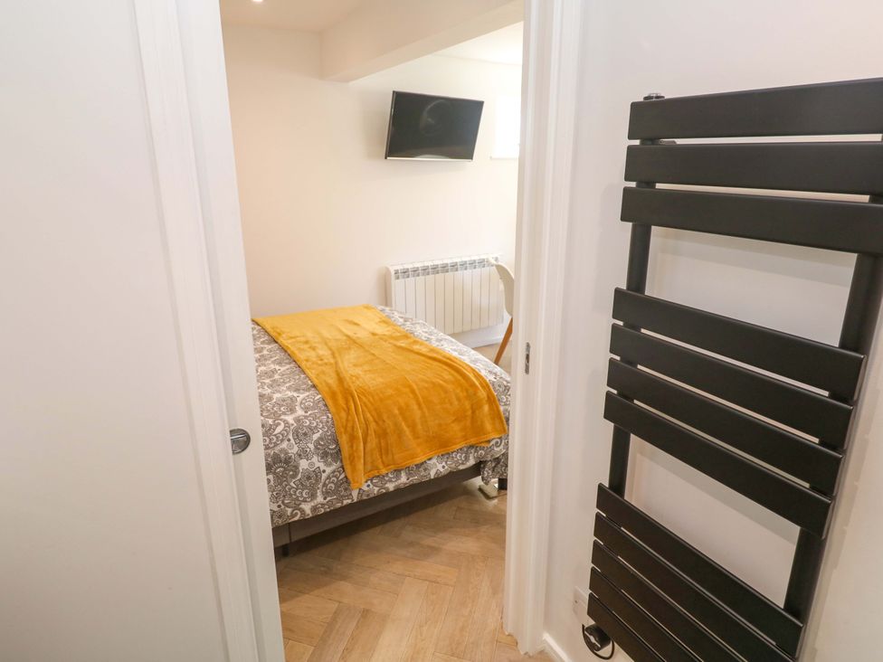 A bedroom with a bed and a TV at The Annex in Penzance