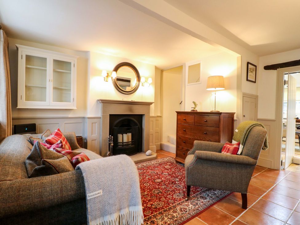 A living room with a fireplace and seating arrangements at Christmas Cottage in Bakewell