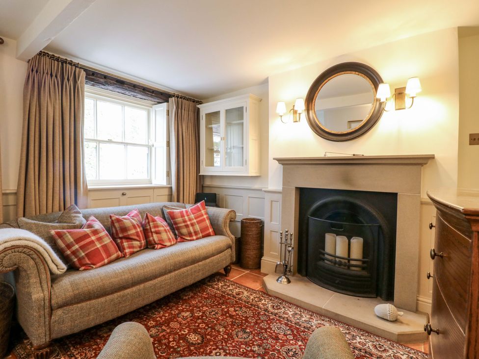 A living room with a sofa and fireplace at Christmas Cottage in Bakewell