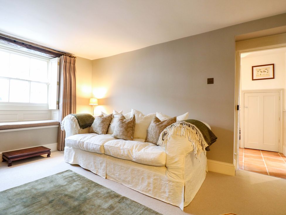 A living room with a sofa and a window at Christmas Cottage in Bakewell