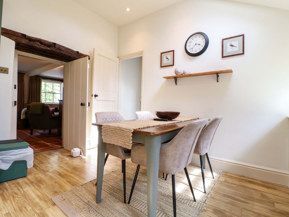A dining room with a table and chairs at Christmas Cottage in Bakewell