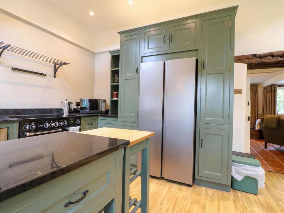 A kitchen with appliances and a countertop at Christmas Cottage in Bakewell