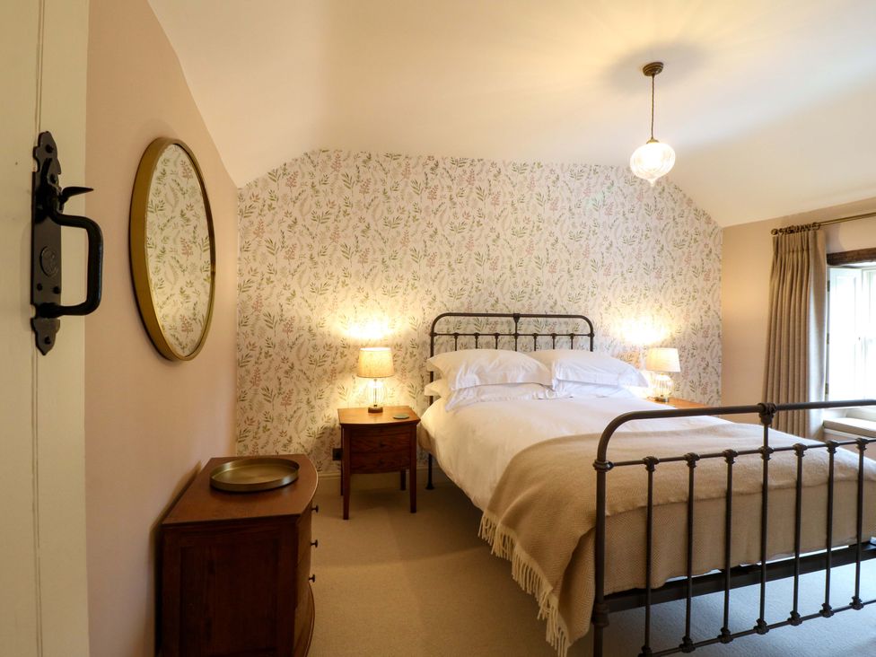 A bedroom with a bed and bedside tables at Christmas Cottage in Bakewell