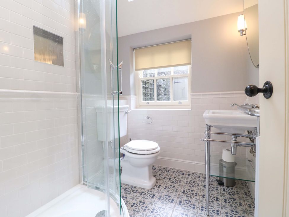 A bathroom with a shower, toilet and sink at Christmas Cottage in Bakewell