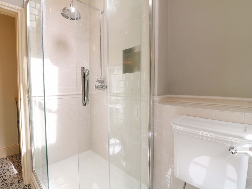 A bathroom with a shower and a toilet at Christmas Cottage in Bakewell