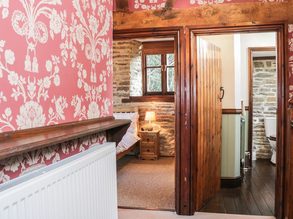A bedroom with a bed and a nightstand at The Granary in Bucknell