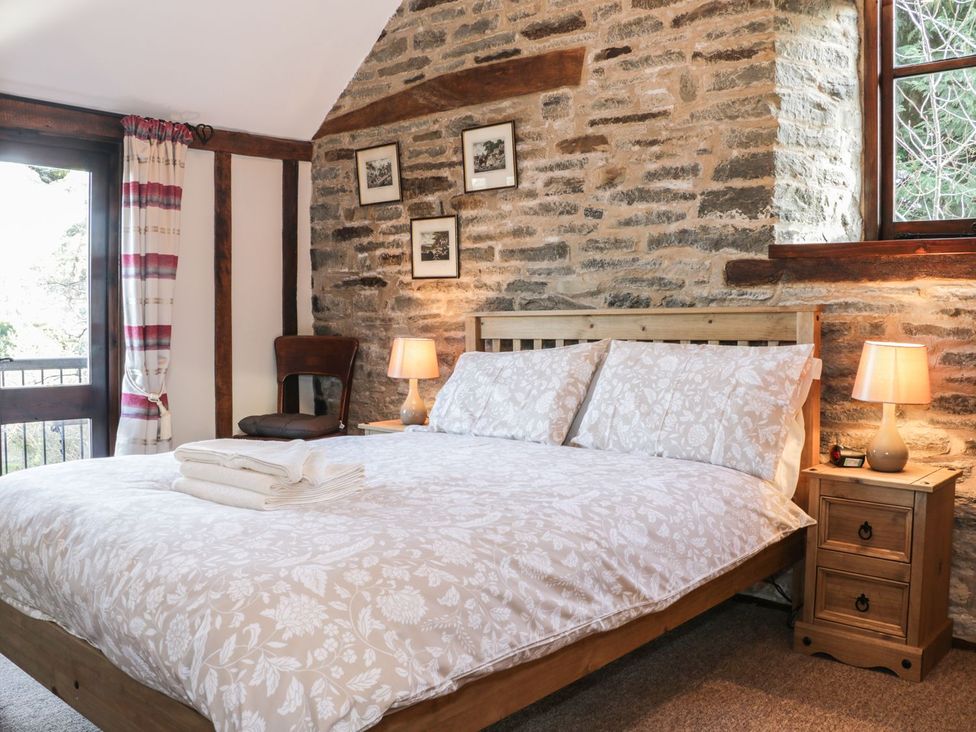 A bedroom with a bed and bedside table at The Granary in Bucknell
