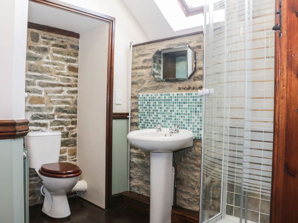 A bathroom with a toilet, sink, and shower at The Granary in Bucknell