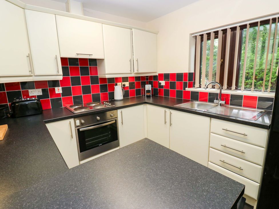 A kitchen with appliances and counters at The Lodge in Brighouse