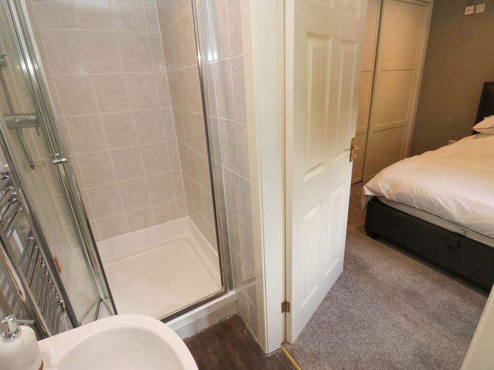 A bathroom with a shower and toilet at The Lodge in Brighouse