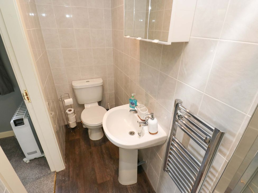 A bathroom with a toilet and sink at The Lodge in Brighouse
