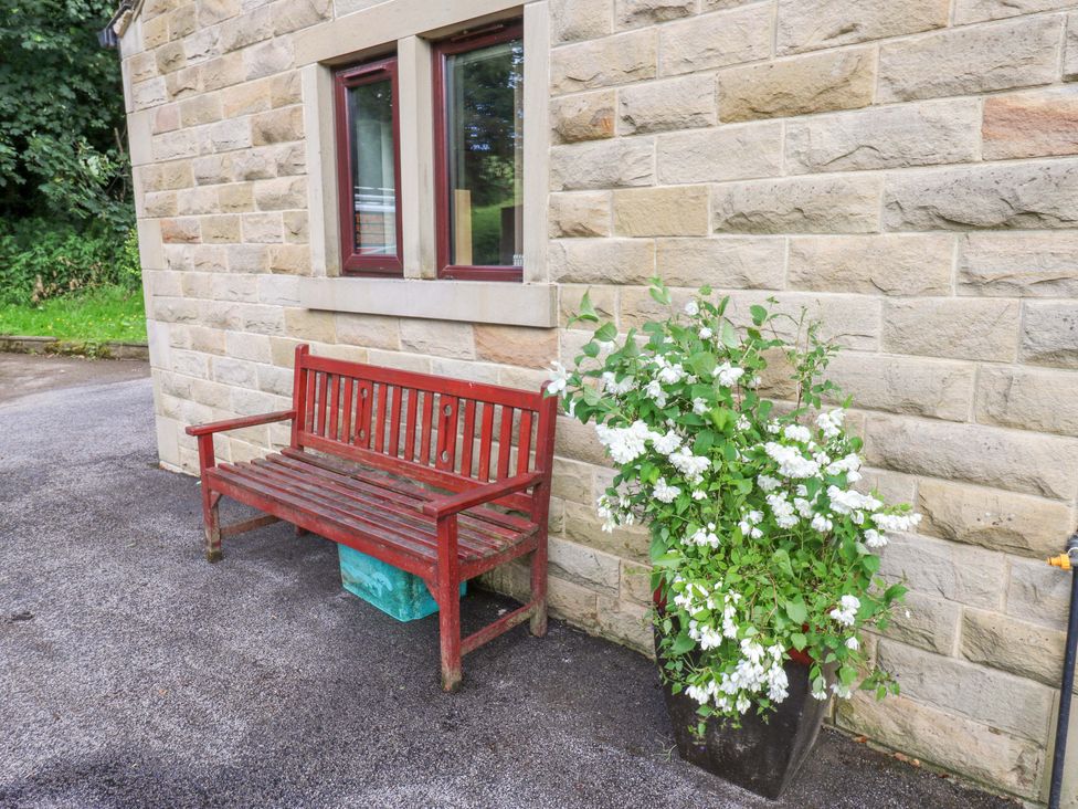 A bench and flower pot at The Lodge in Brighouse