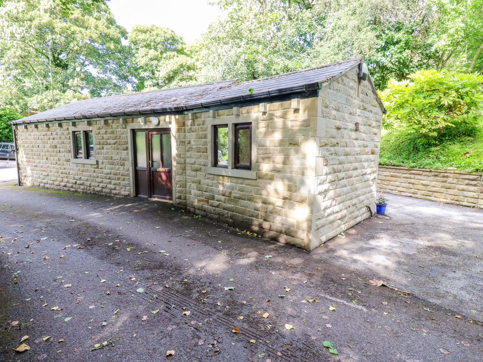 A building with windows and a door in an outdoor area at The Lodge in Brighouse