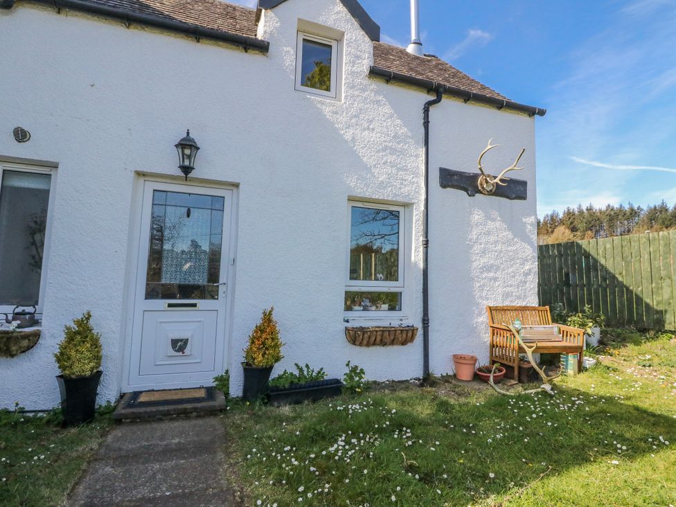 An exterior view of a house with a door and bench at Schoolhouse in Oban