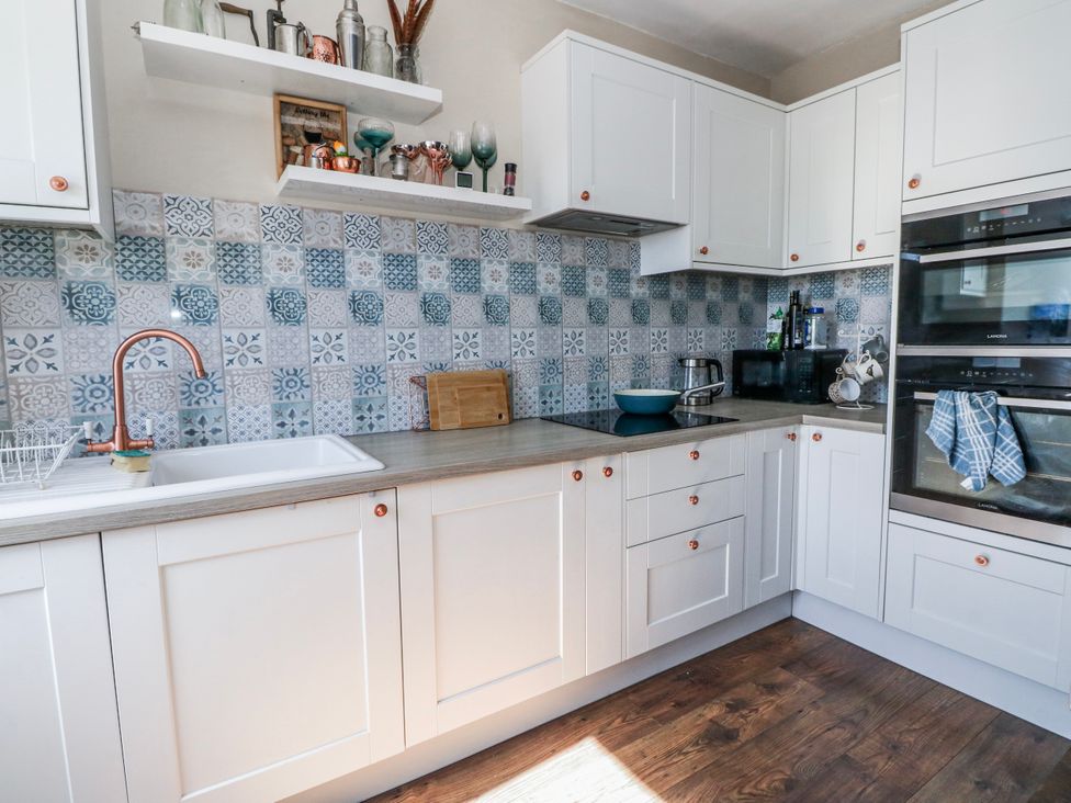 A kitchen with a sink and stove at Schoolhouse in Oban