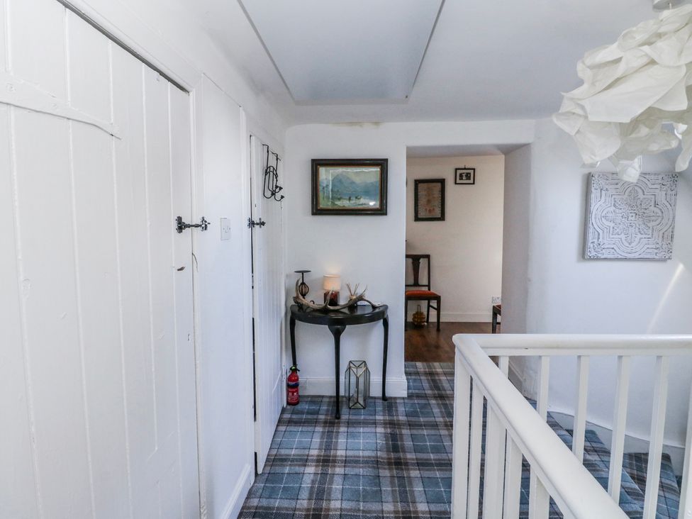 A hallway with a table and decor at Schoolhouse in Oban