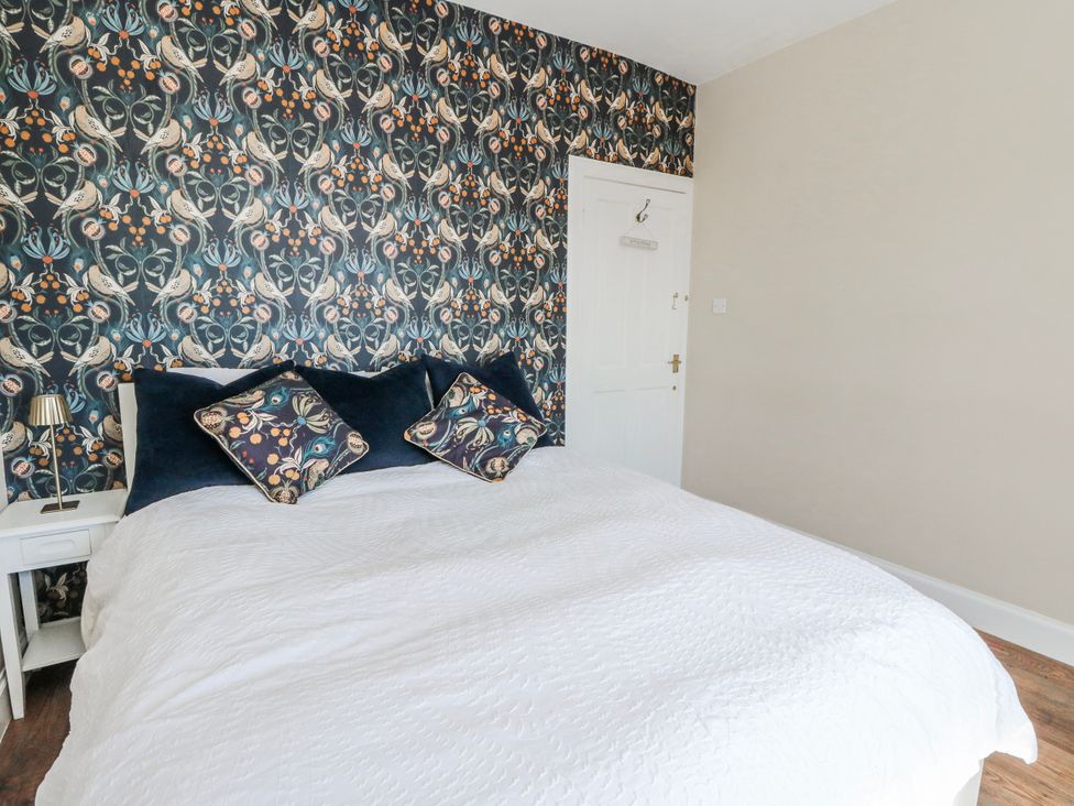 A bedroom with a bed and nightstand at Schoolhouse in Oban