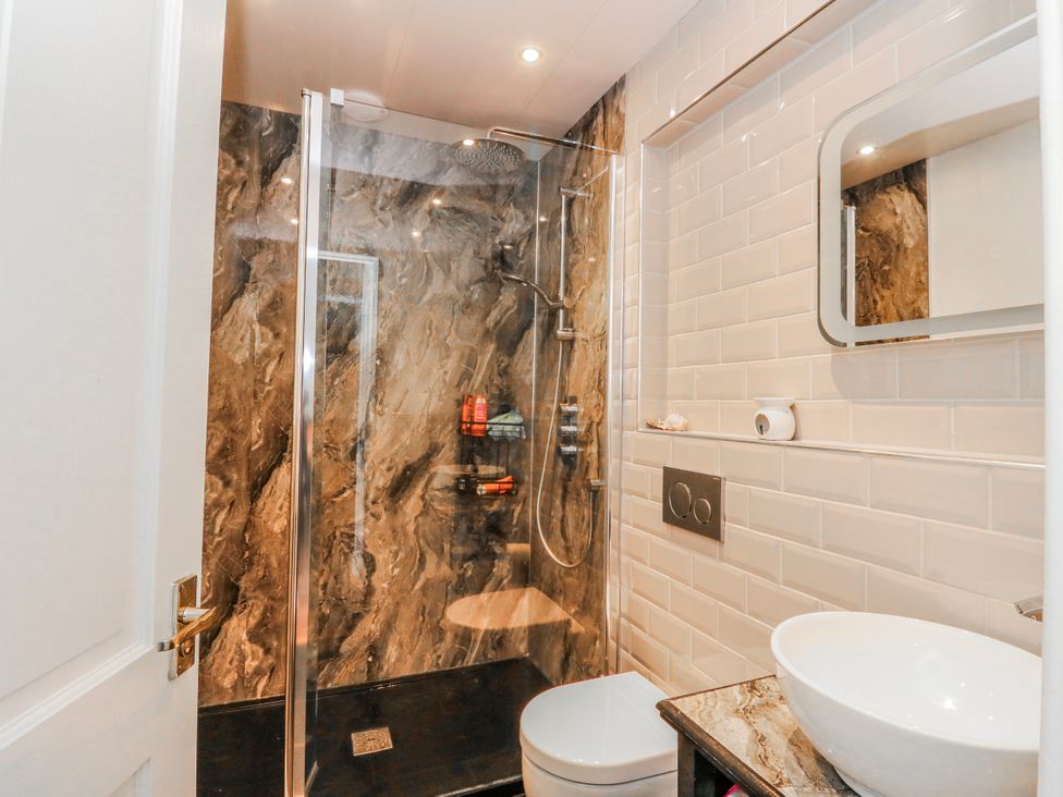 A bathroom with a shower, toilet, and sink at Schoolhouse in Oban