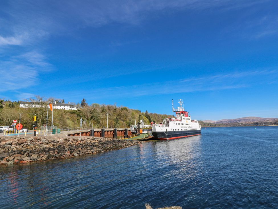 A boat at the dock by the water at Schoolhouse in Oban