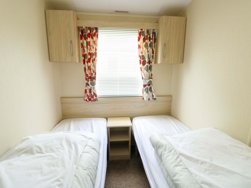 A bedroom with two beds and a window at W629 in Abergele