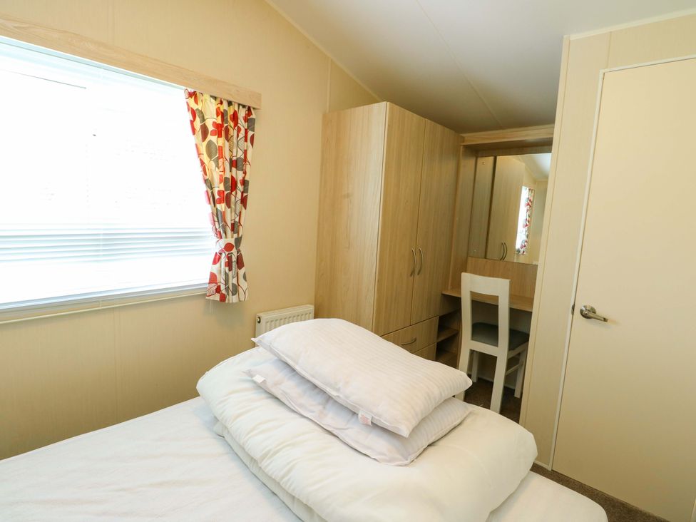 A bedroom with a bed and wardrobe at W629 in Abergele