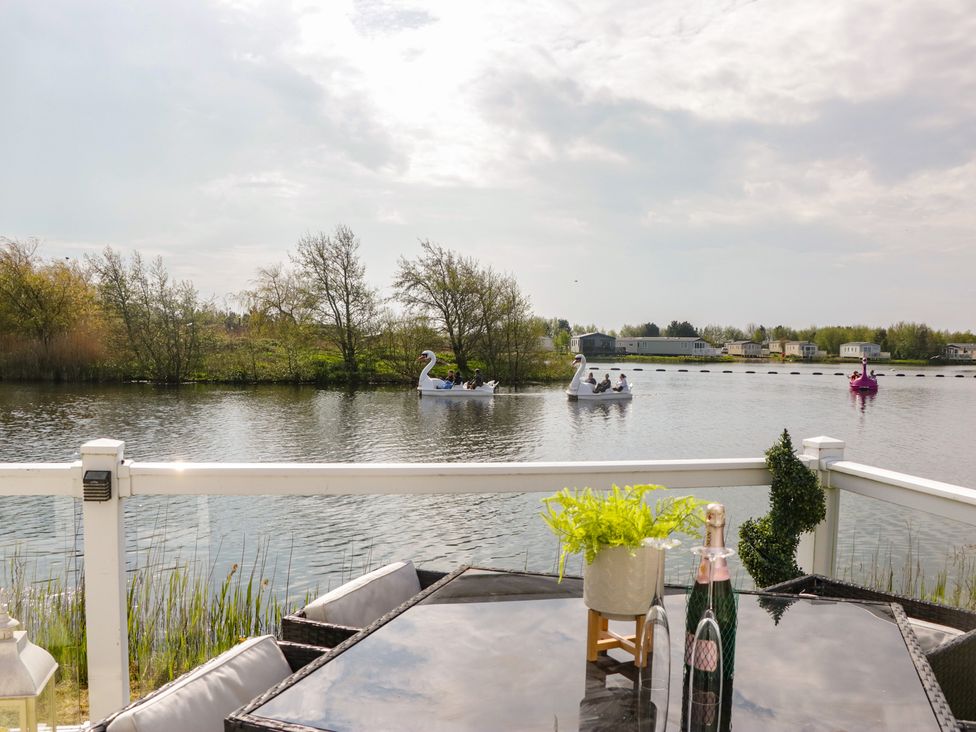 An outdoor area with a lake and swan-shaped boats at Swan Haven in Grange-Over-Sands
