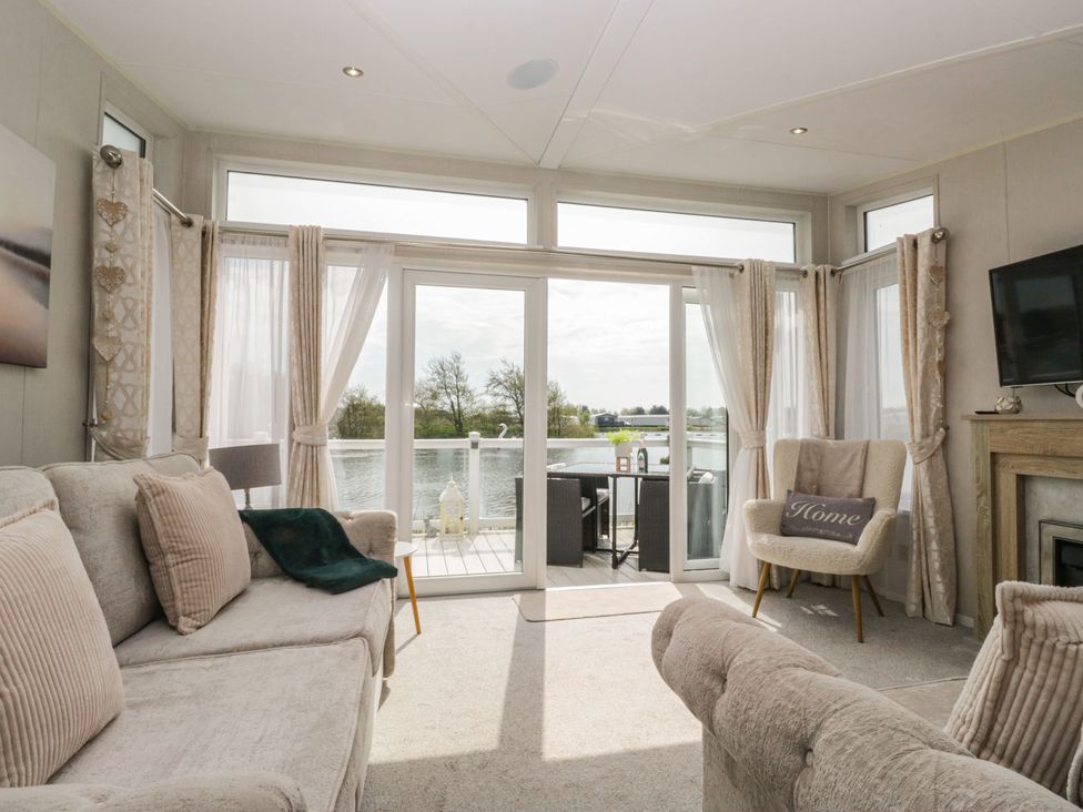 A living room with a view of the water at Swan Haven in Grange-Over-Sands