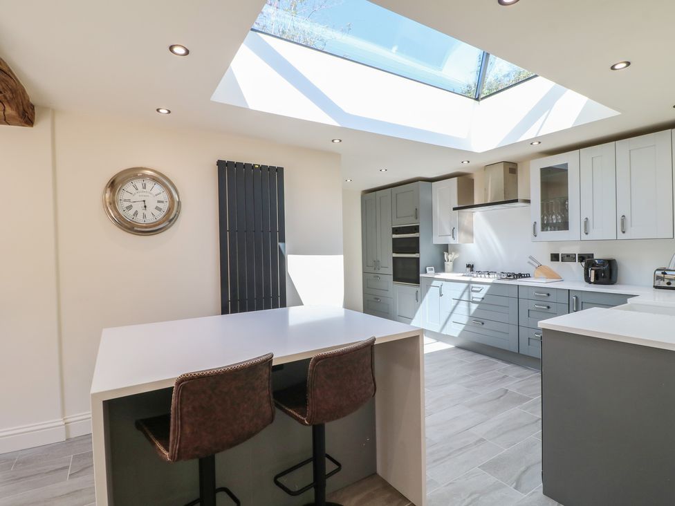 A kitchen with a table and chairs at Gardener’s Cottage in Oakham