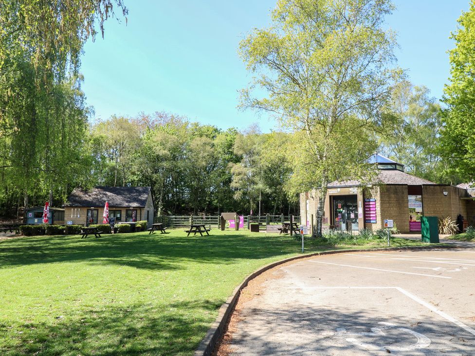 An outdoor area with buildings and benches at Gardener’s Cottage in Oakham