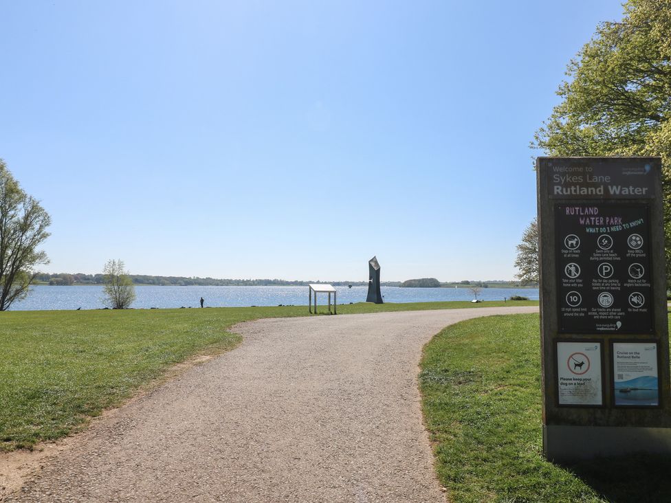 A signboard and pathway near water at Sykes Lane Rutland Water in Oakham