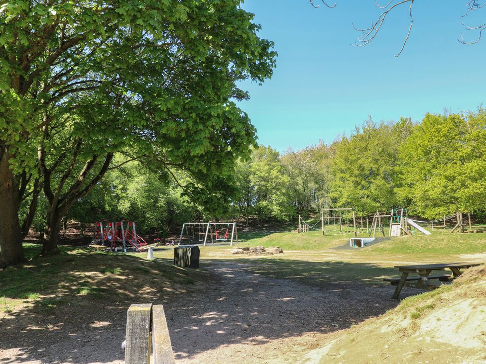 A playground with swings and a slide at an outdoor park