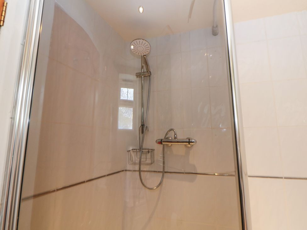 A shower with a showerhead and valve at Ivy Cottage in Matlock