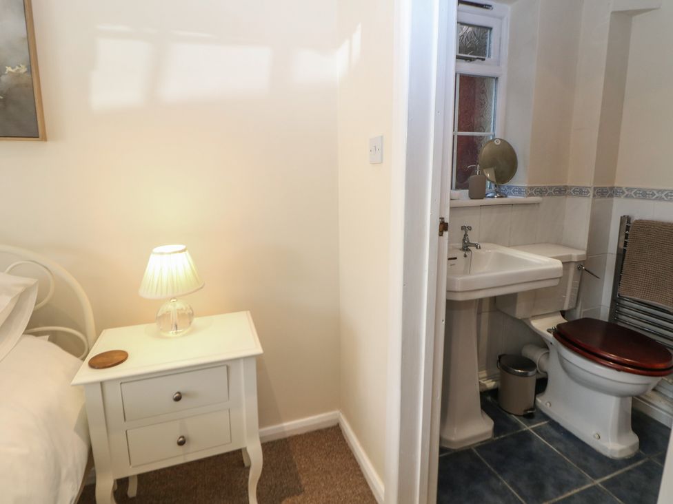 A bathroom with a toilet and sink at Ivy Cottage in Matlock