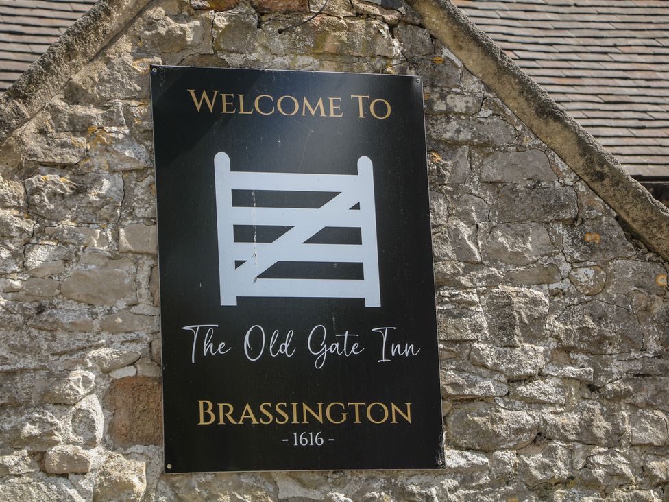 A welcome sign for The Old Gate Inn at Brassington