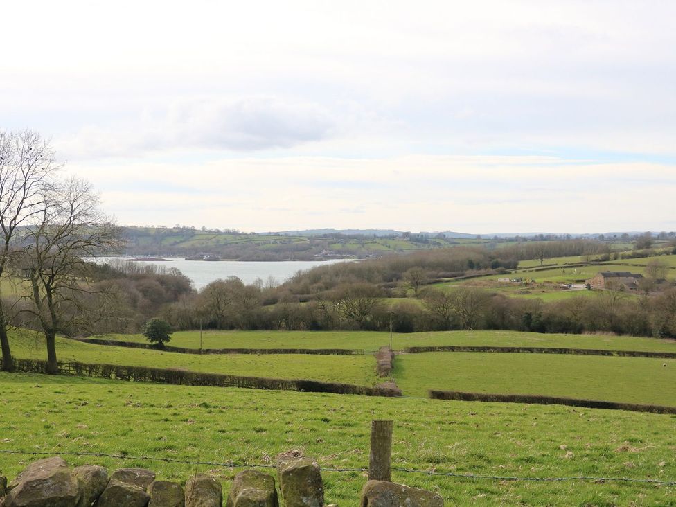 A landscape view of fields and a lake at Ivy Cottage in Matlock