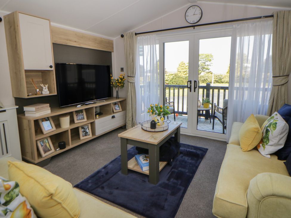 A living room with a TV and coffee table at Santa Maria in Llandysul
