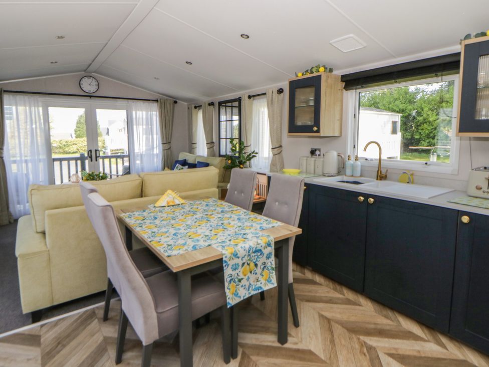 A living room with a dining table and sofa at Santa Maria in Llandysul