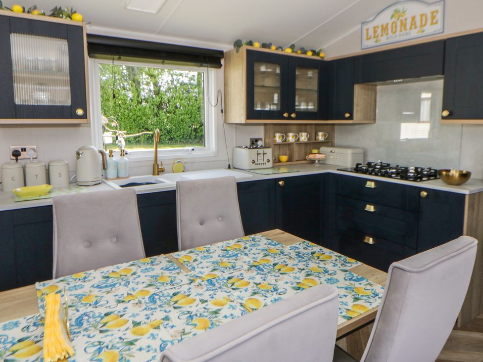 A kitchen with a table and chairs at Santa Maria in Llandysul